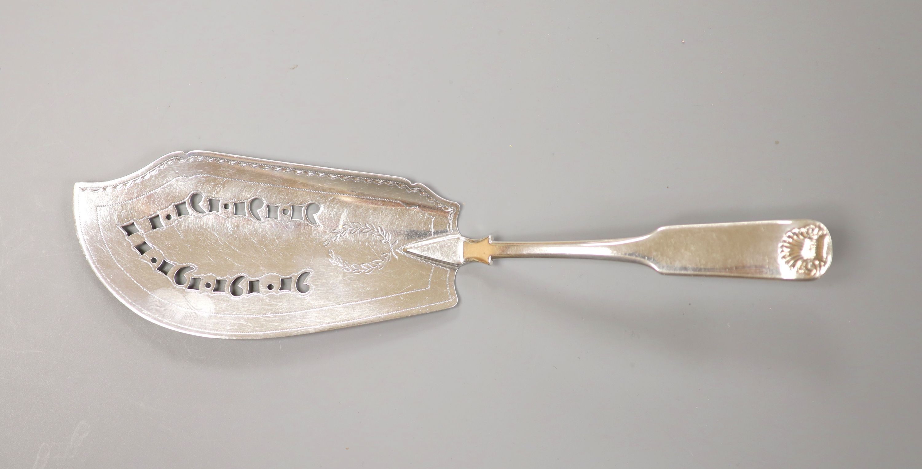 A George III Scottish silver fiddle and shell pattern fish slice, John Graham, Edinburgh, c. 1806 (marks rubbed), 30cm, 139 grams.